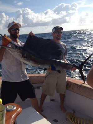 Nephew Shane, (on right,) with his caught and released 6 foot Sailfish